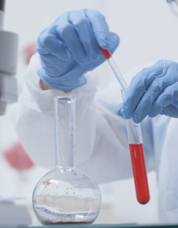 close-up-researcher-holding-glassware-min